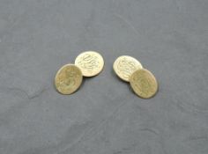 A pair of 18ct gold cufflinks having monogrammed oval discs with figure of eight connectors,