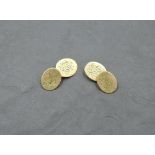 A pair of 18ct gold cufflinks having monogrammed oval discs with figure of eight connectors,