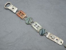 An early 20th century white metal and agate bracelet, with oval and pierced tablet shaped links in
