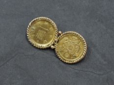 A Japanese Meiji period coin brooch, formed from two double gold one Yen coins within a rope-twist