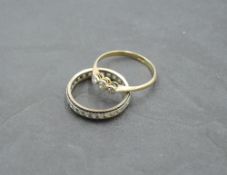 A diamond trilogy ring, total approx 0.15ct in collared mounts on a yellow metal loop stamped