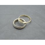 A diamond trilogy ring, total approx 0.15ct in collared mounts on a yellow metal loop stamped