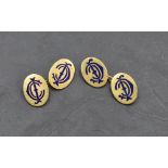 A pair of yellow metal cufflinks stamped 18ct, of oval form bearing blue enamel monograms, with