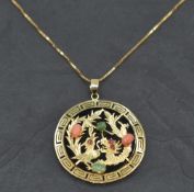 An Oriental Phoenix & Dragon pendant having coral, jade and ruby chip decoration on a black