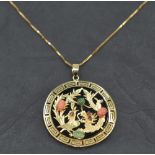 An Oriental Phoenix & Dragon pendant having coral, jade and ruby chip decoration on a black