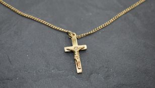 A 9ct gold crucifix pendant and chain, approx 22' & 5.2g