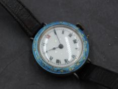 A lady's vintage silver wrist watch having Roman numeral dial to decorative white enamel face in