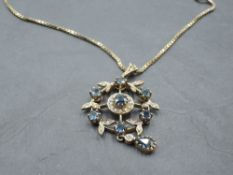 An Edwardian style 9ct gold pendant having central sapphire and diamond cluster in a diamond and