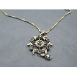 An Edwardian style 9ct gold pendant having central sapphire and diamond cluster in a diamond and