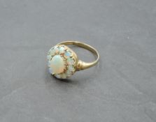 An oval opal cluster ring in a stepped claw mount on a 9ct gold loop, size R & approx 1.7g