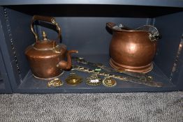 A copper coal helmet bucket, a copper stove kettle and a selection of horse brasses