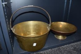 A vintage brass cast jam pan with cast handle and similar footed copper bowl
