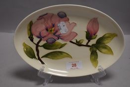 A modern Moorcroft Pottery dish in the Magnolia pattern bearing green signature to back