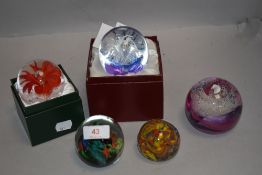 A selection of art glass paper weights including fish bowl, lamp work flower and Royal Crest