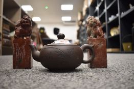 A Yixing Zisha Chinese tea tea pot and two soap stone carved dogs of fo
