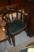 An early 20th Century elbow chair having spindle back and green leather seat, looks nice quality