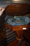 A 19th Century mahogany sewing table having octagonal top, partially fitted interior, on triple
