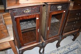 A pair of 19th Century mahogany side cabinets having frieze drawer and glazed foot , on cabriole
