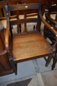 A period oak armchair having rail back and solid seat
