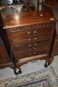 A late 19th or early 20th Century mahogany chest of six typical drop front drawers, having ball