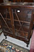 An early 20th Century mahogany display cabinet having astral glazed doors and two lower drawers