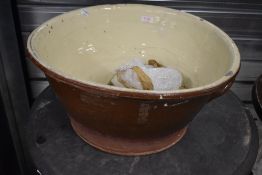 An antique salt glazed dough or similar mixing bowl of large proportions
