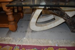 An Itallian designer coffee table having modernist style base with marble laminated base