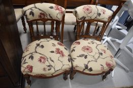 A pair of Edwardian inlaid mahogany salon nursing chairs