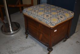 A 19th Century mahogany and rosewood low stool, having woolwork top, column supports and