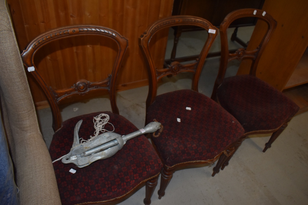 Three Victorian dining chairs having mahogany frames fluted legs with carved balloon style backs