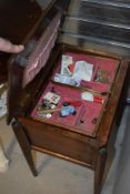 A mid 20th Century oak and ply sewing table and contents