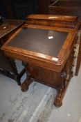 A 19th Century walnut davenport having satinwood inlay and interior drawers , four side drawers