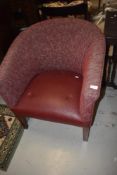 An Art Deco style tub chair having leatherette seat and burgundy upholstery on square legs