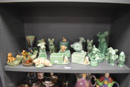 20th century Sylvac and Wade figures including pipe holders, green glaze dogs and similar