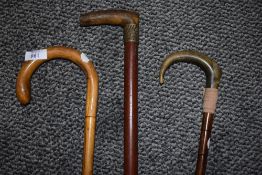 Three vintage walking canes, to included horn handled example and another with silver toned embossed