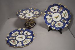 Two Victorian porcelain scalloped plates painted with butterfly and flowers with matching comport in