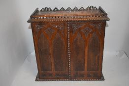 Victorian Gothic shallow carved smoker or similar cabinet in mahogany