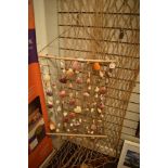 A hammock having wooden batons to ends and a shell wall hanging.