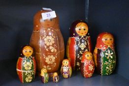 A set of seven Russian Soviet era hand decorated nesting dolls plus one