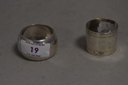 HM silver napkin rings one of cylinder form marked FE and similar of plain form