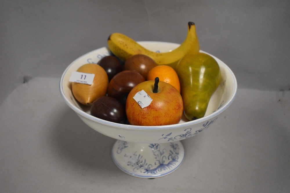 Dutch delft footed bowl hand decorated, containing an assortment of wooden fruit