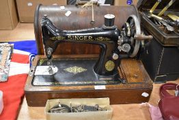 A Singer sewing machine with case. Model number F15270888, to included a vintage chocolate box