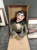 An early 20th century Papier Mache headed Ventriloquist Dummy with black moulded hair and painted