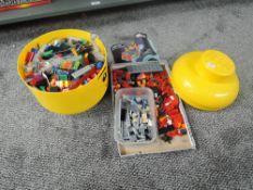 A collection of mixed vintage Lego including yellow circular storage box, figures and many pieces