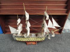 A hand made wooden and painted scale model, 1765 HMS Victory, complete with cannons and rigging,