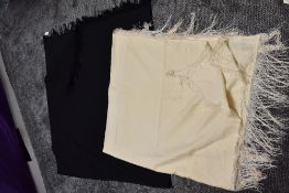 Two antique fringed shawls,wool or wool blend,one cream the other black.