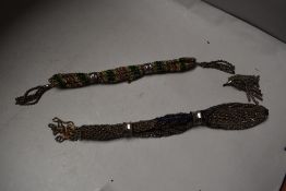 Two late Georgian/early Victorian misers purses having original cut steel bands.