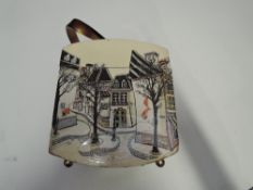 A 1950s box bag having celluloid handle and Parisian scenes to sides, later relined in blue felt.