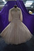 A striking late 1940s dress of taupe coloured embroidered cotton tulle having statement collar