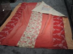 A large early 20th century patchwork quilt using red ,coral and beige cottons and backed with cotton